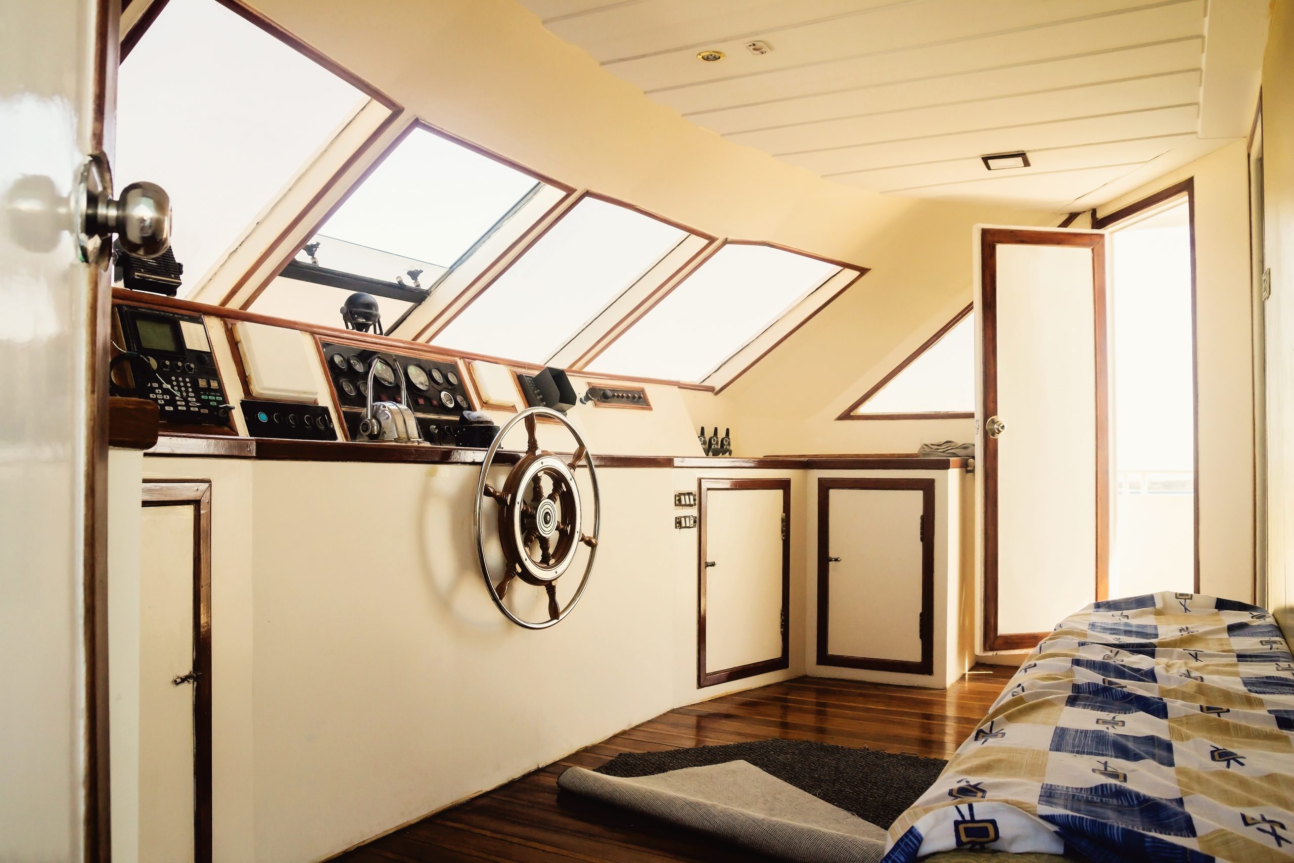 Captain's cabin and steering wheel, close-up on a yacht.