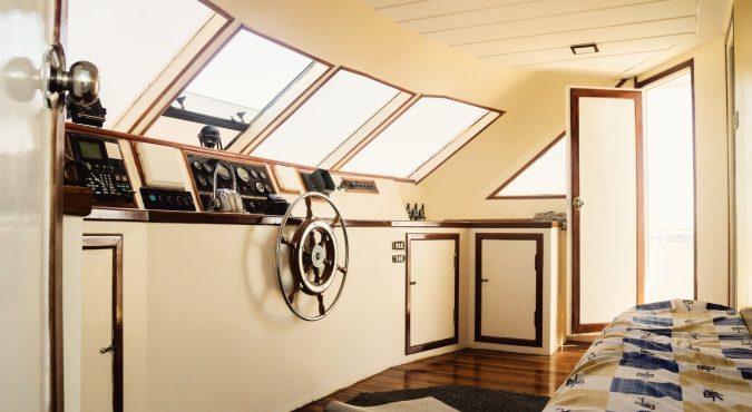 Captain's cabin and steering wheel, close-up on a yacht.